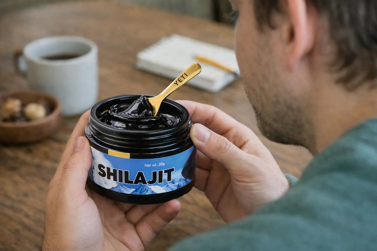 A jar of Yeti Life shilajit resin held with a measuring spoon